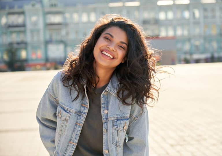 Happy,African,Young,Woman,Wearing,Denim,Jacket,Laughing,Looking,At